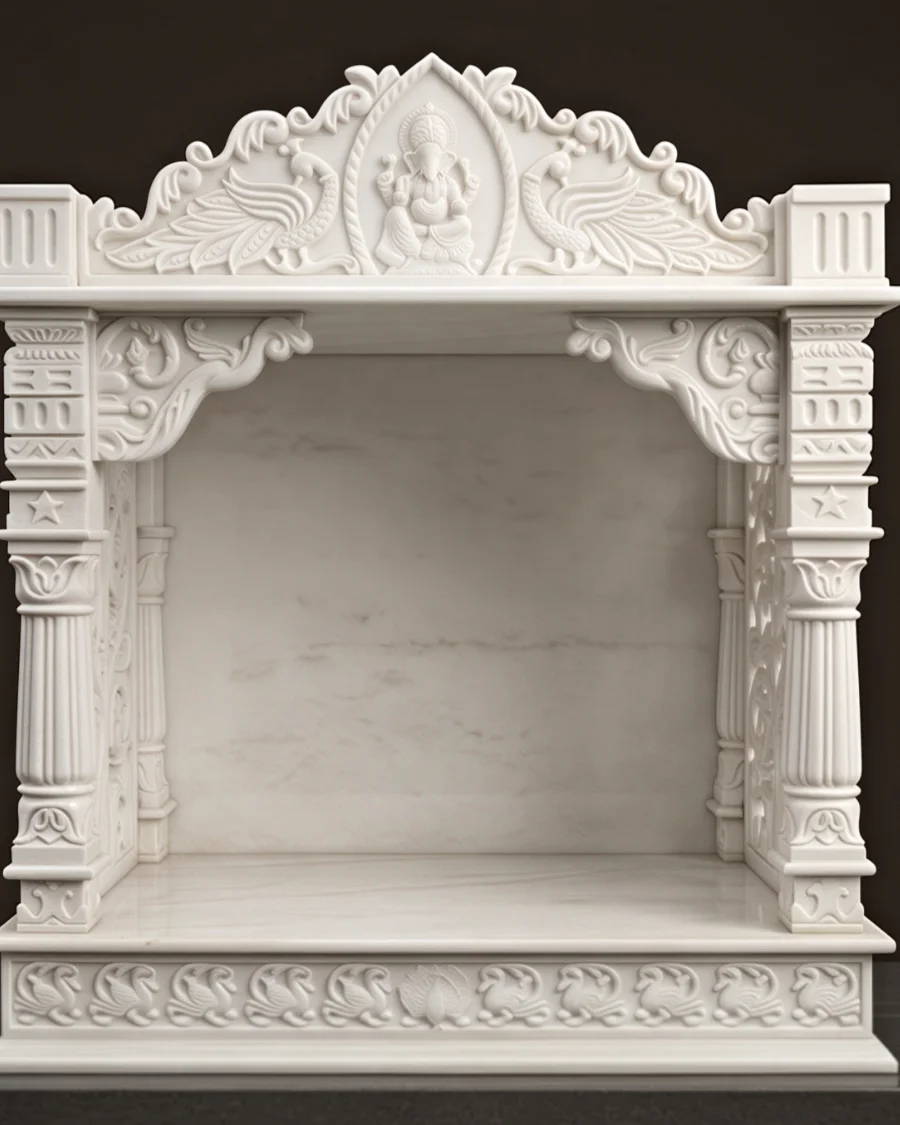 Hand-carved white marble mandir with a Ganesh crest and pierced jali sides