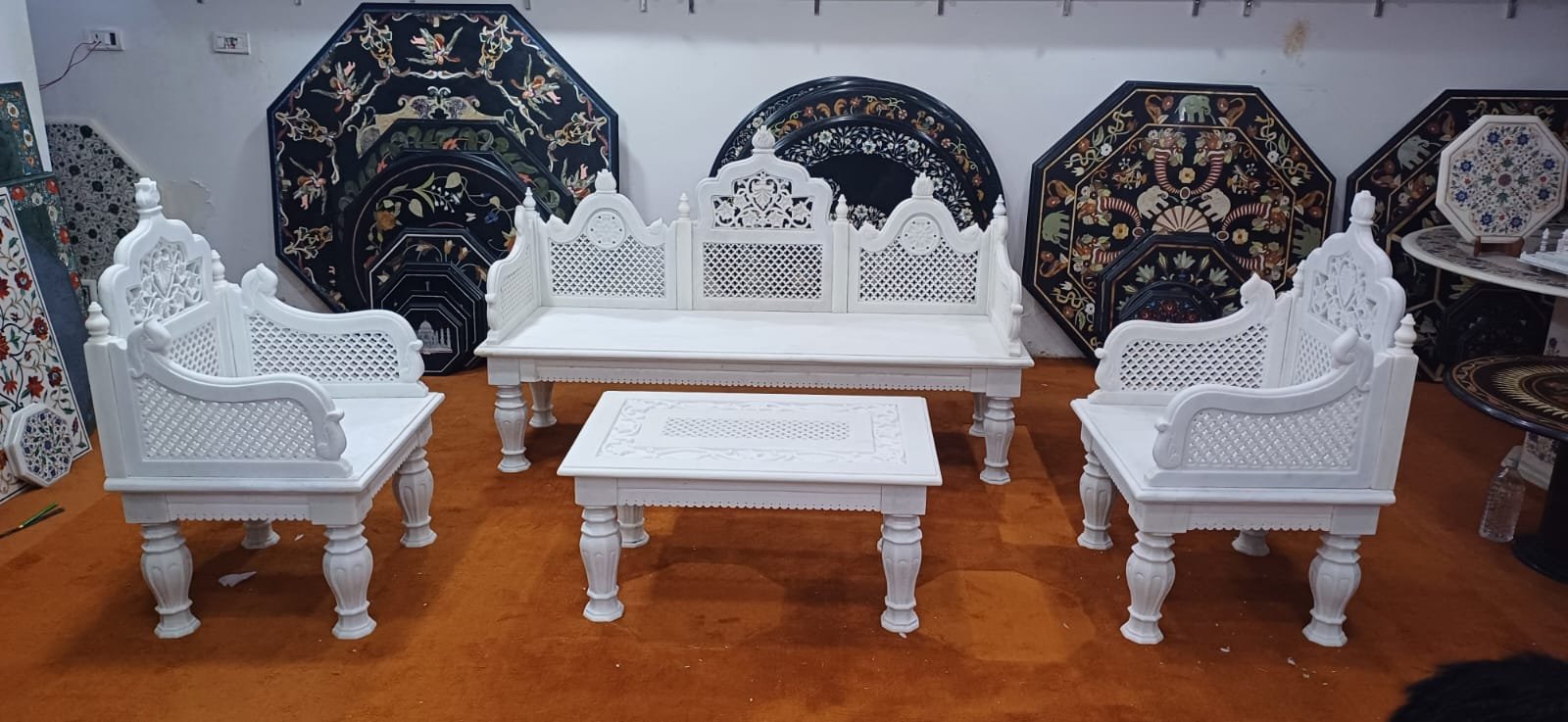 A carved marble seating set with pietra dura inlay