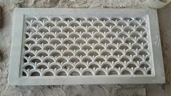 A pierced fan-lattice jali carved by hand in white Makrana marble at the Sasdas Marble workshop