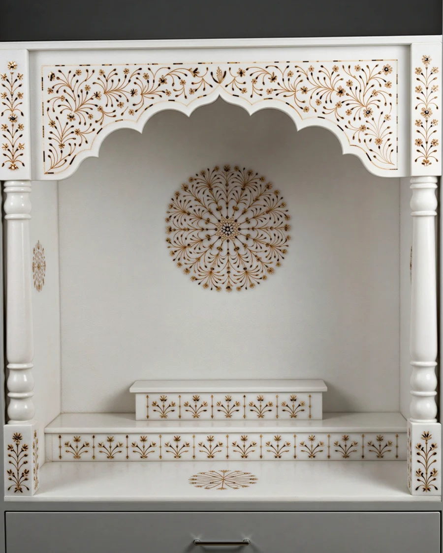 White marble mandir with a gold floral inlay arch and pierced jali sides