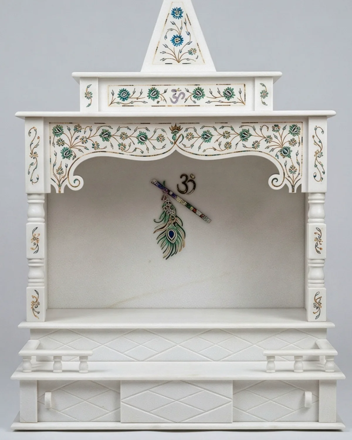 White marble temple for home with a carved shikhar spire and green floral inlay borders